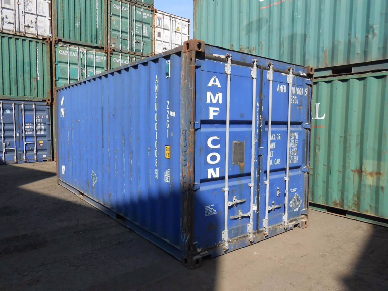 Conteneur maritime 20 pieds pose sur un terrain, utilise comme stockage exterieur